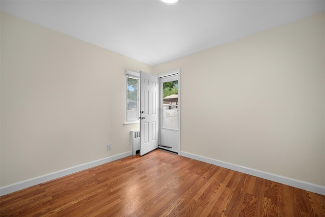 2057 Renfrew Ave, Elmont, NY 11003 - empty room with baseboards, light wood-type flooring, and radiator