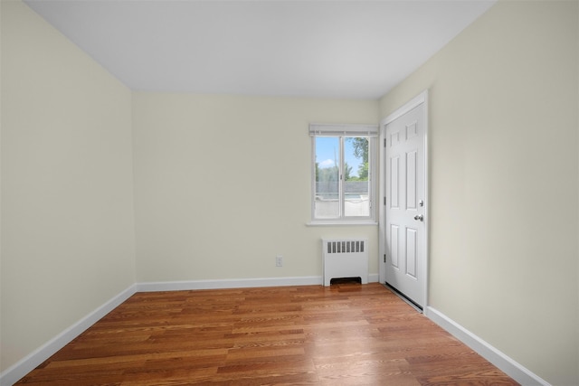 2057 Renfrew Ave, Elmont, NY 11003 - empty room featuring radiator, wood finished floors, and baseboards
