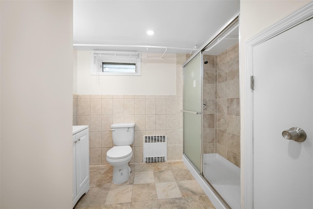 2057 Renfrew Ave, Elmont, NY 11003 - bathroom with radiator, tile walls, a shower stall, toilet, and vanity