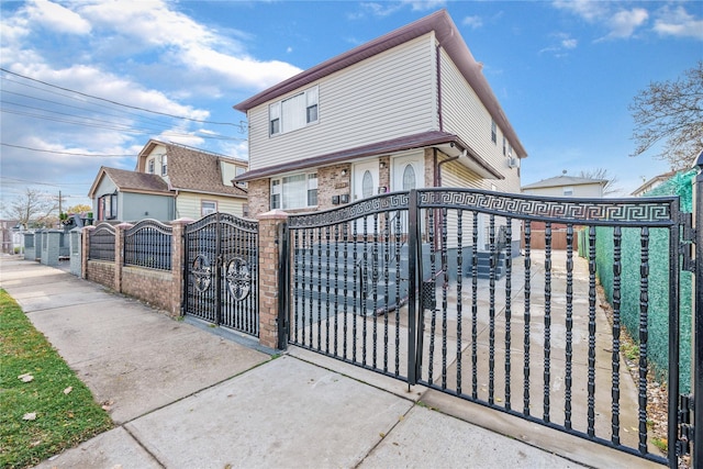 view of gate with a fenced front yard