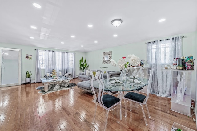 dining space with light wood-type flooring and recessed lighting