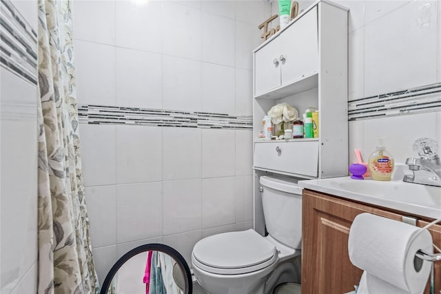 full bathroom with a shower with curtain, tile walls, toilet, and vanity