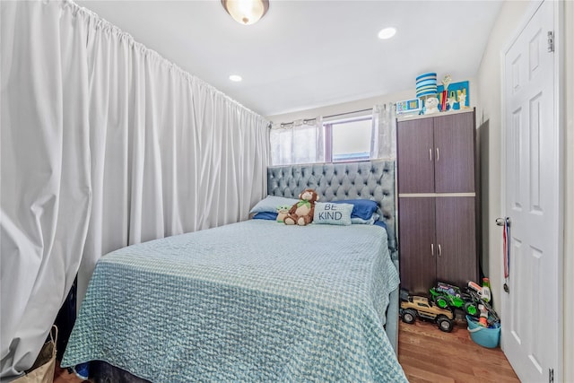 bedroom featuring wood finished floors and recessed lighting