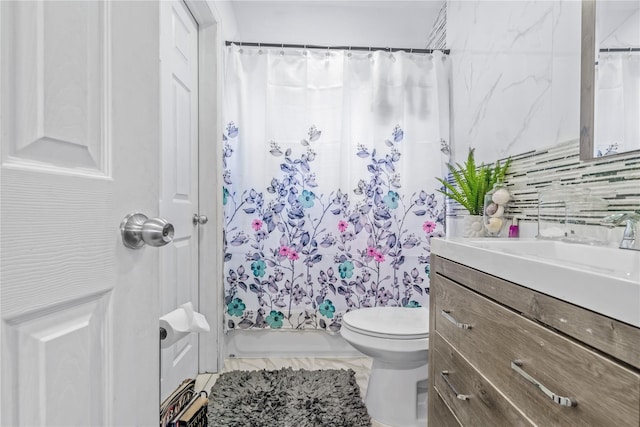 bathroom featuring shower / tub combo, vanity, and toilet