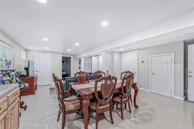 dining space featuring light tile patterned floors, baseboards, and recessed lighting