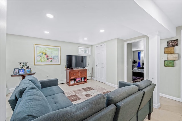 living room featuring recessed lighting, baseboard heating, and baseboards