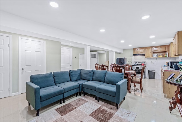 living area featuring light tile patterned floors and recessed lighting