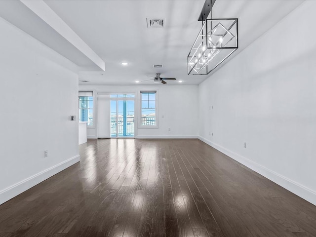 141 Marina Pointe Dr, East Rockaway, NY 11518 - unfurnished living room featuring baseboards, visible vents, dark wood-type flooring, ceiling fan with notable chandelier, and recessed lighting