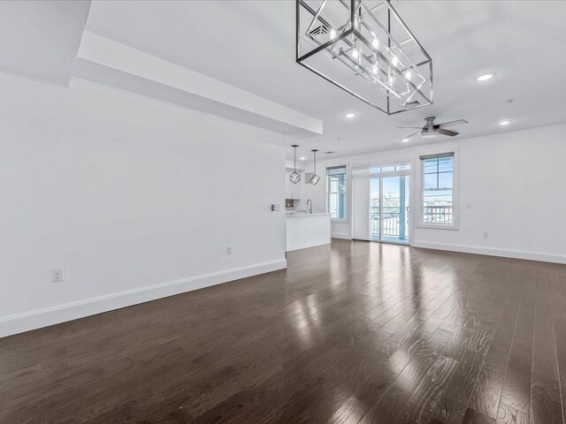141 Marina Pointe Dr, East Rockaway, NY 11518 - unfurnished living room with dark wood-type flooring, baseboards, and a ceiling fan