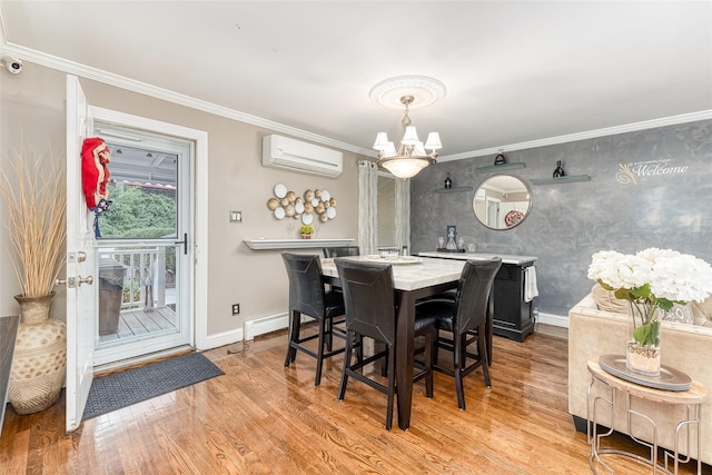 dining area with a notable chandelier, baseboards, light wood finished floors, a wall mounted air conditioner, and crown molding