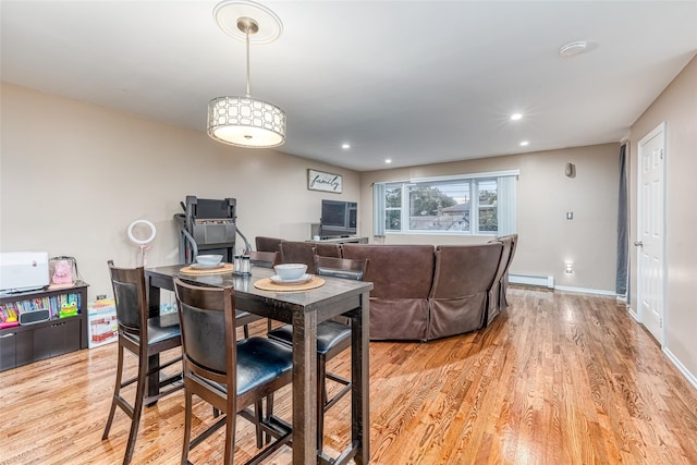 dining space featuring baseboards, baseboard heating, recessed lighting, and light wood-style floors