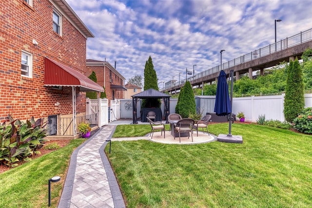 view of yard featuring fence private yard, a patio, and a gazebo