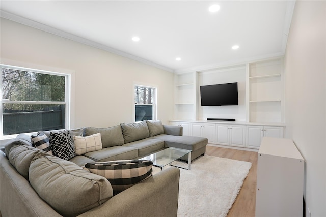 living room featuring ornamental molding, light wood-type flooring, built in shelves, and recessed lighting