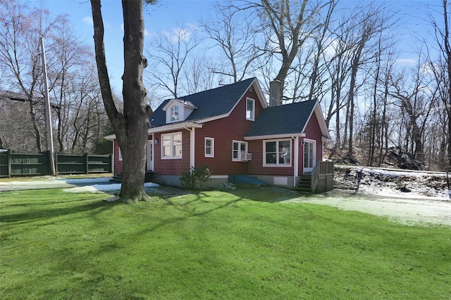 view of property exterior with entry steps, fence, a yard, driveway, and roof with shingles