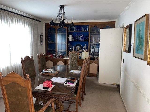 dining area featuring carpet flooring and a notable chandelier