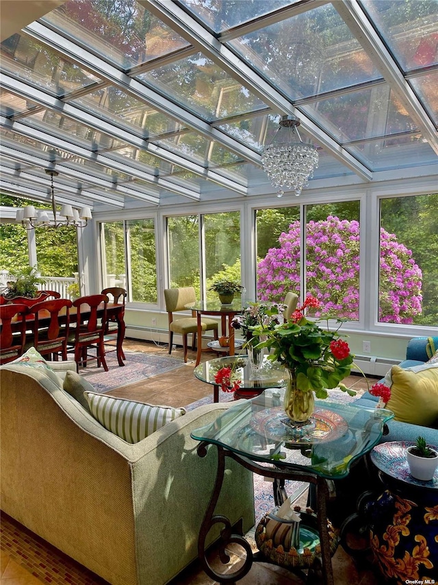 sunroom featuring a baseboard heating unit and a chandelier