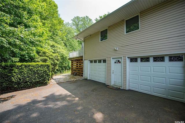 view of side of home with a garage and stairway