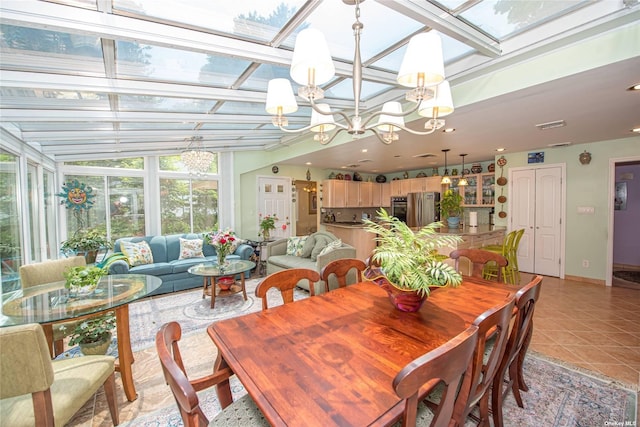 dining space featuring a skylight, recessed lighting, light tile patterned flooring, a chandelier, and baseboards