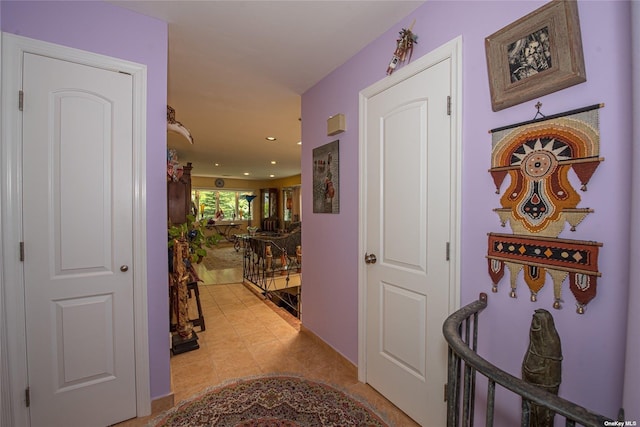 hallway with recessed lighting and light tile patterned flooring