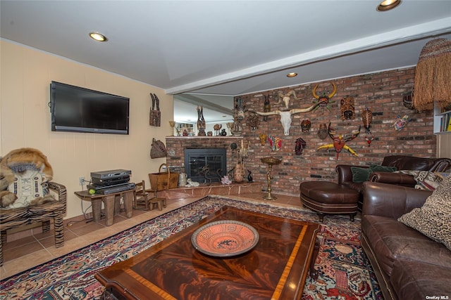 living room with a glass covered fireplace, recessed lighting, brick wall, and tile patterned floors