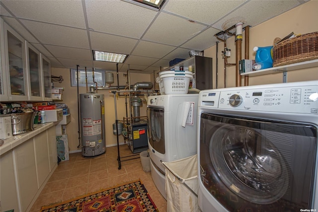 clothes washing area featuring laundry area, water heater, independent washer and dryer, and light tile patterned flooring