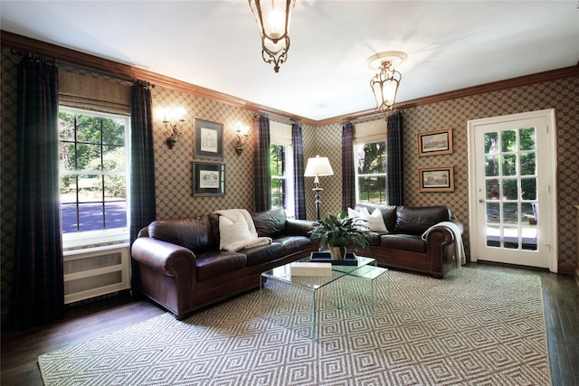 living area featuring ornamental molding, wood finished floors, and wallpapered walls