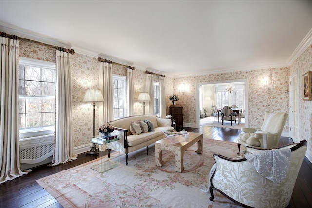 living room with dark wood-style floors, plenty of natural light, and wallpapered walls