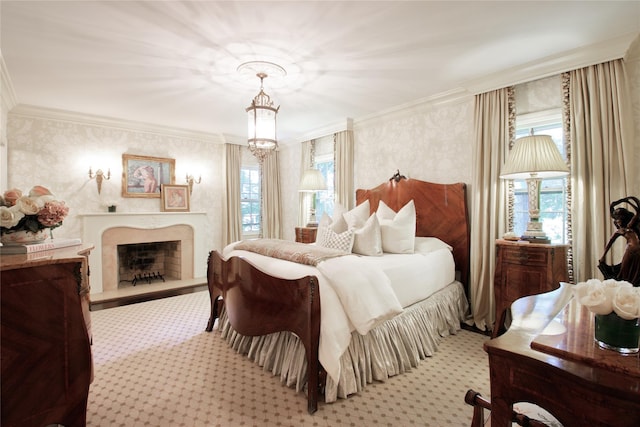 bedroom with light carpet, a premium fireplace, a chandelier, and crown molding