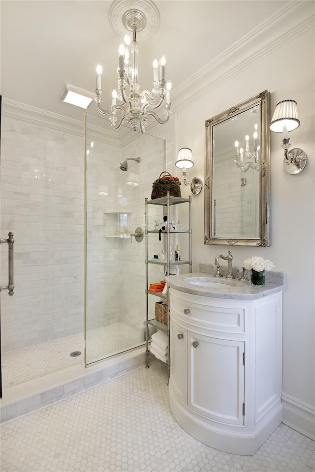 bathroom with ornamental molding, a tile shower, and vanity