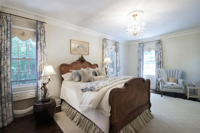 bedroom featuring a chandelier, baseboards, wood finished floors, and crown molding