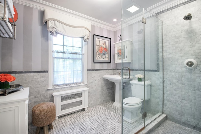 bathroom featuring toilet, a wainscoted wall, ornamental molding, tile patterned floors, and radiator