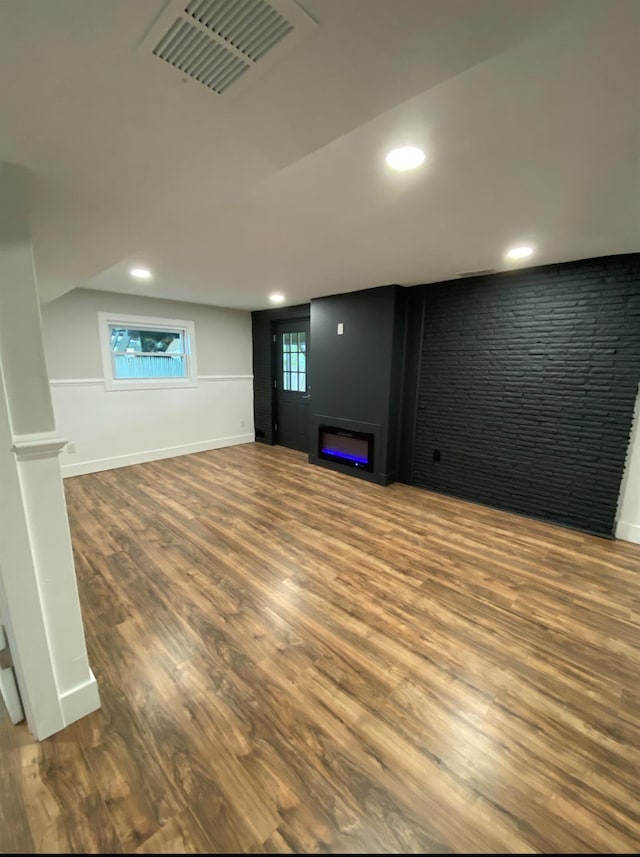 basement with recessed lighting, visible vents, baseboards, and wood finished floors