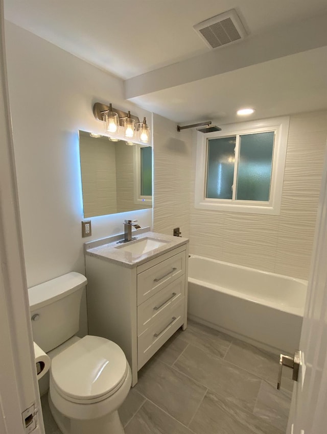 full bathroom with visible vents, vanity, toilet, and bathing tub / shower combination