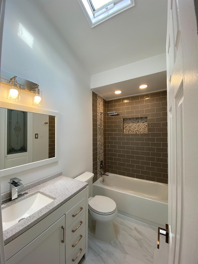 bathroom featuring toilet, a skylight, vanity, marble finish floor, and shower / bathing tub combination