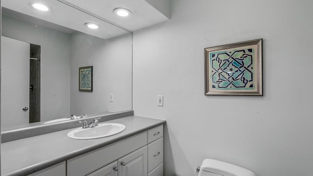 full bathroom featuring recessed lighting, vanity, and toilet