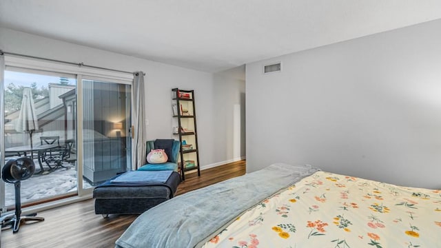 bedroom with access to exterior, baseboards, dark wood-style floors, and visible vents