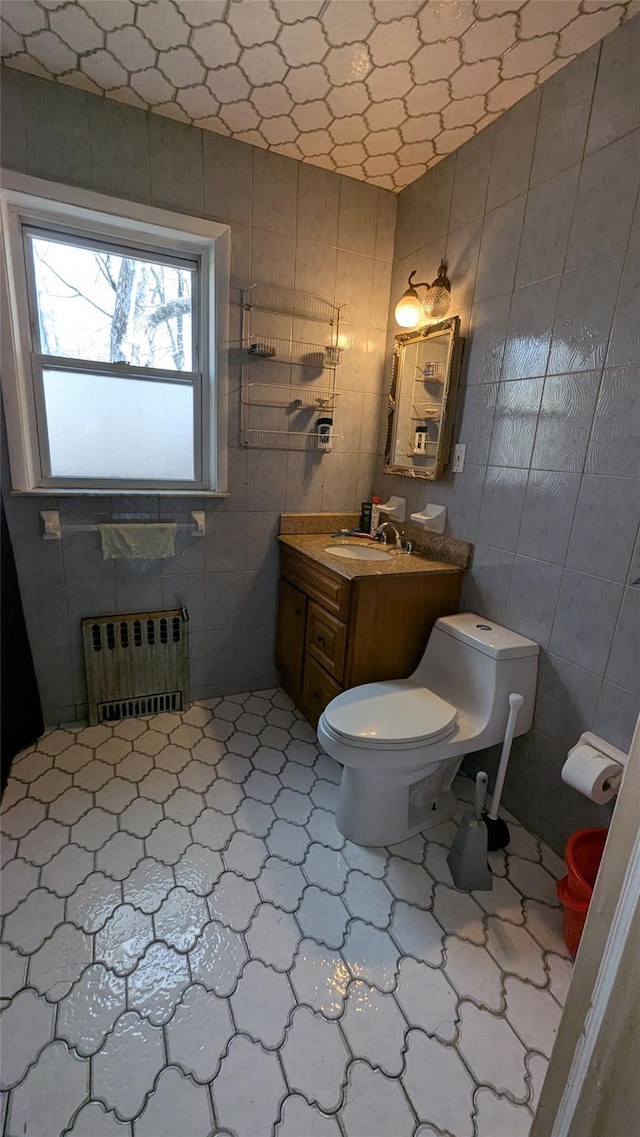 bathroom featuring radiator, vanity, and toilet