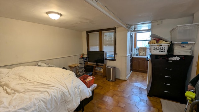 bedroom with a wainscoted wall