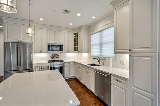 kitchen with dark wood-style floors, light countertops, visible vents, appliances with stainless steel finishes, and a sink