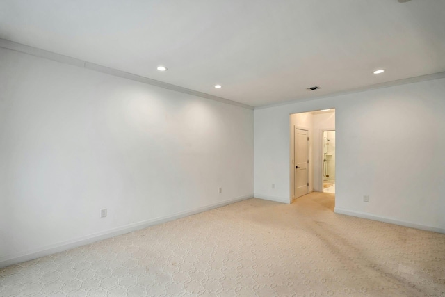 spare room with recessed lighting, light carpet, visible vents, baseboards, and crown molding