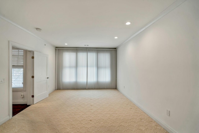 empty room with ornamental molding, recessed lighting, and baseboards