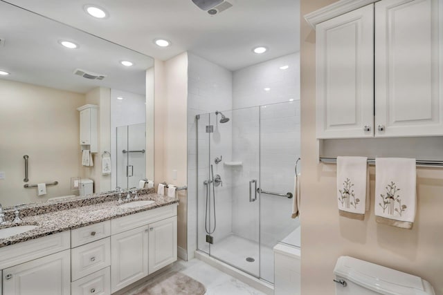 full bathroom with toilet, a stall shower, visible vents, and a sink