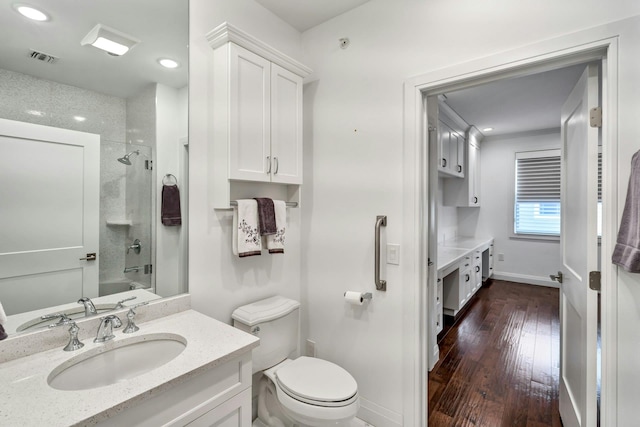 bathroom featuring baseboards, visible vents, toilet, hardwood / wood-style flooring, and vanity