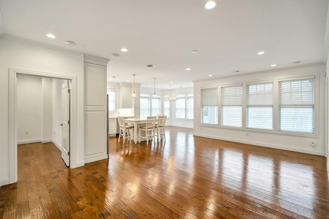 unfurnished living room featuring baseboards, hardwood / wood-style floors, and recessed lighting