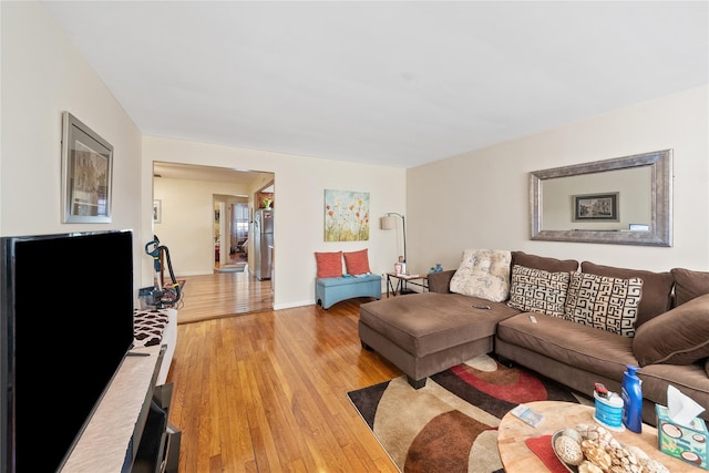 living room with light wood-type flooring and baseboards