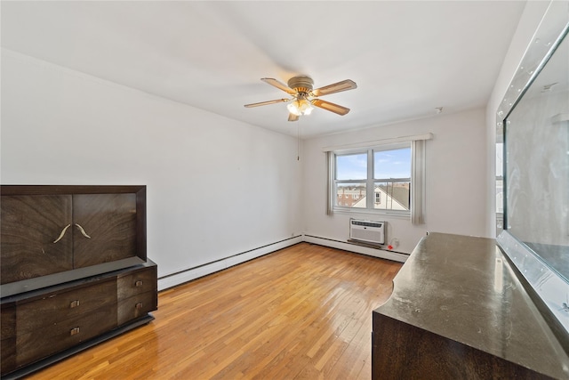 interior space featuring ceiling fan, light wood-style flooring, baseboard heating, and a wall mounted air conditioner