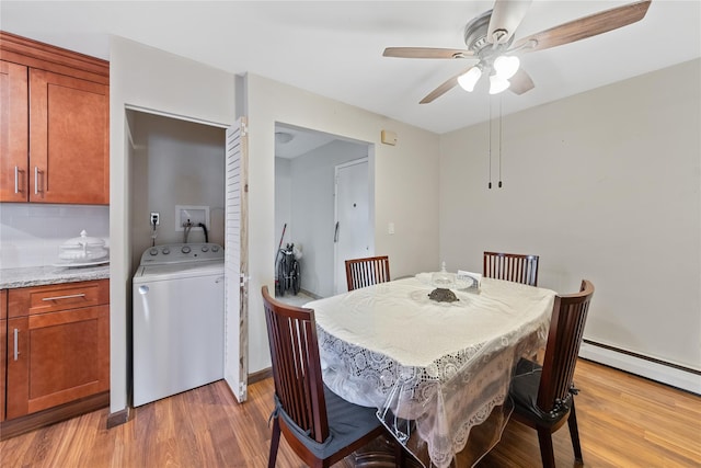 dining space with a baseboard heating unit, washer / clothes dryer, light wood-style flooring, and a ceiling fan