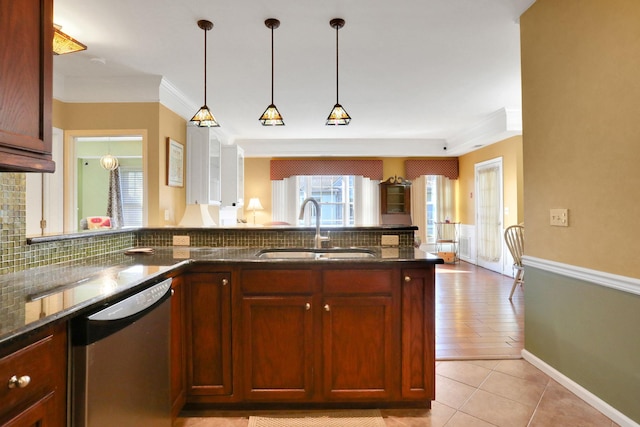 kitchen featuring a sink, tasteful backsplash, ornamental molding, and dishwasher