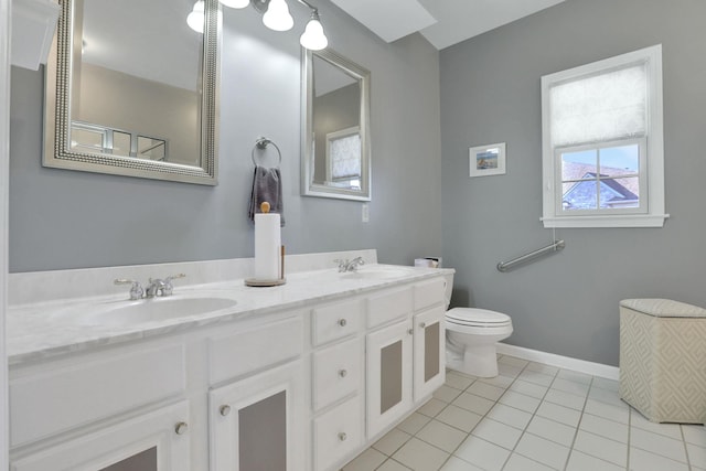 bathroom with tile patterned flooring, a sink, toilet, and baseboards