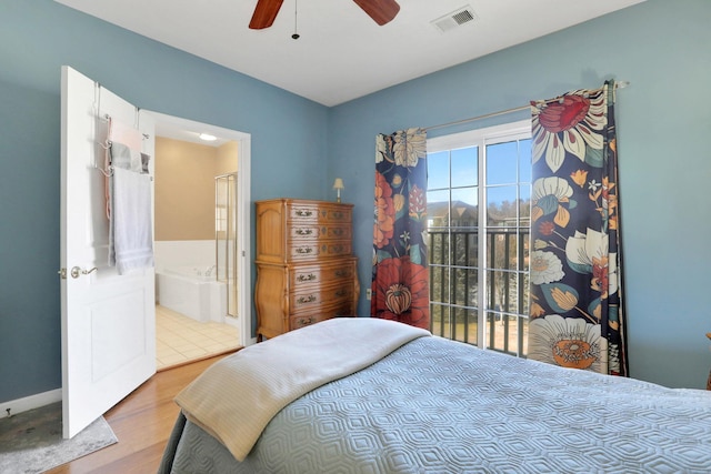 bedroom featuring a ceiling fan, visible vents, ensuite bathroom, and wood finished floors